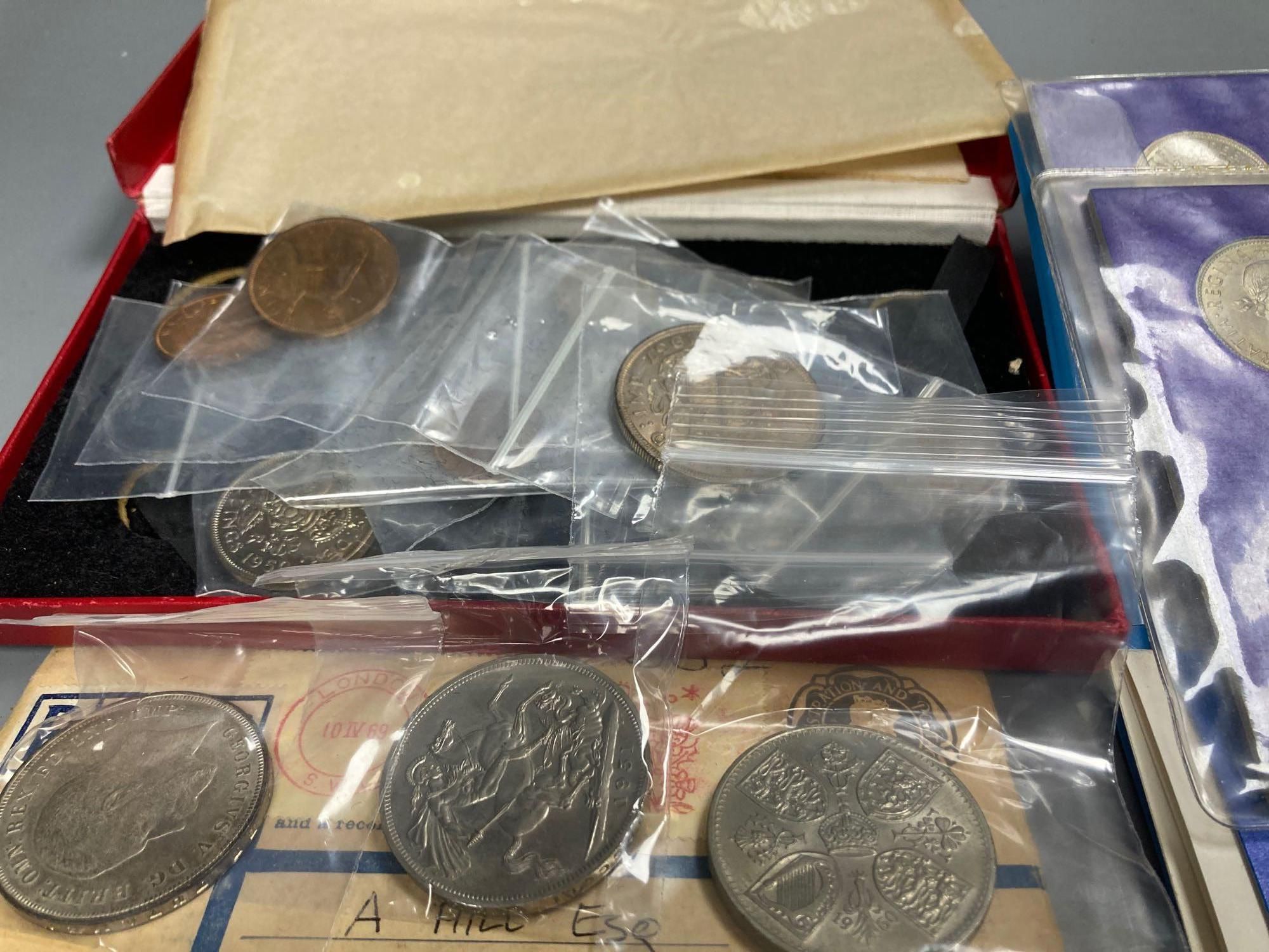 A collection of assorted loose coins including crowns and a Constantine II